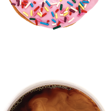 A coffee with cream & A strawberry frosted donut with sprinkles