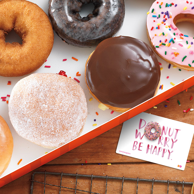 A Box Of Donuts On Wood Table With Dd Card