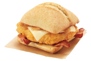 A Dunkin’ Donuts Chicken Bacon Sandwich on a Croissant, on a napkin.