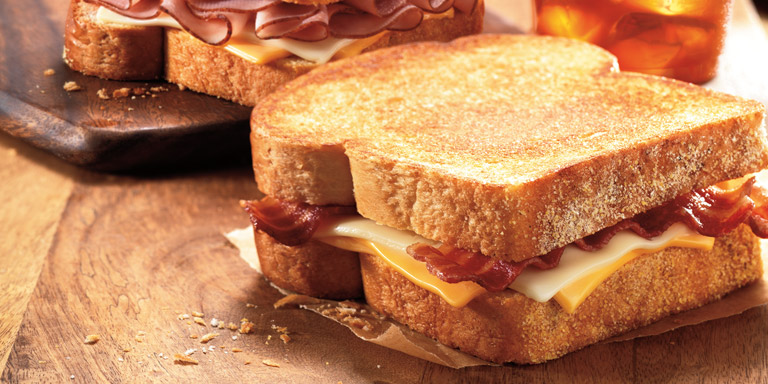 Two Dunkin’ Donuts Deluxe Grilled Cheese sandwiches on Texas Toast.