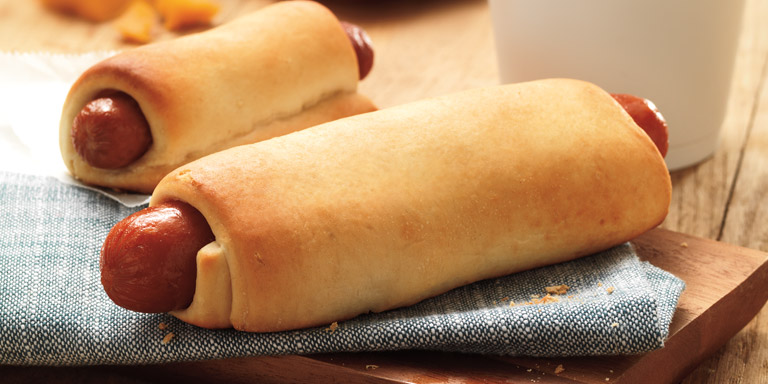 Two Dunkin’ Donuts Kolache sandwiches on a blue napkin.