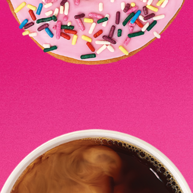 A women drinking a Dunkin' Donuts hot coffee.