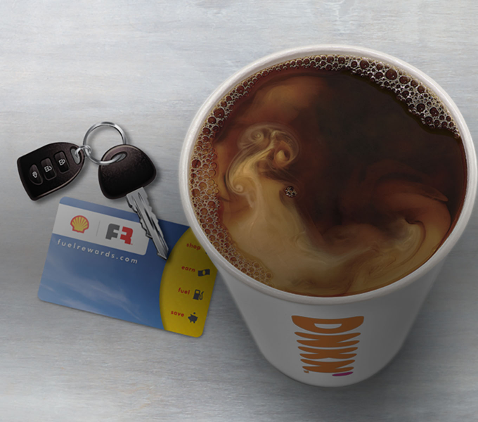 A football laying on a field with the Dunkin' Donuts mobile app open on a mobile phone.