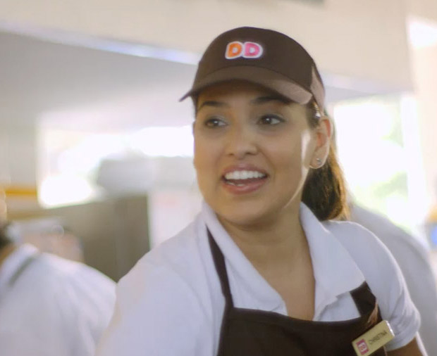 A smiling Dunkin' Donuts employee.
